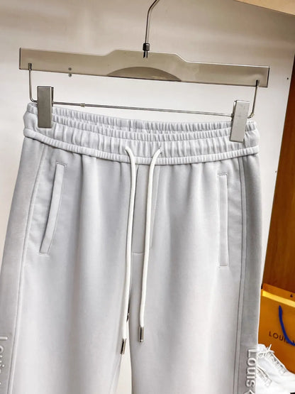 Side‑Embossed Letter Snap‑Detail Pants