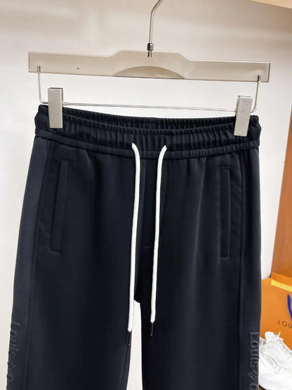Side‑Embossed Letter Snap‑Detail Pants